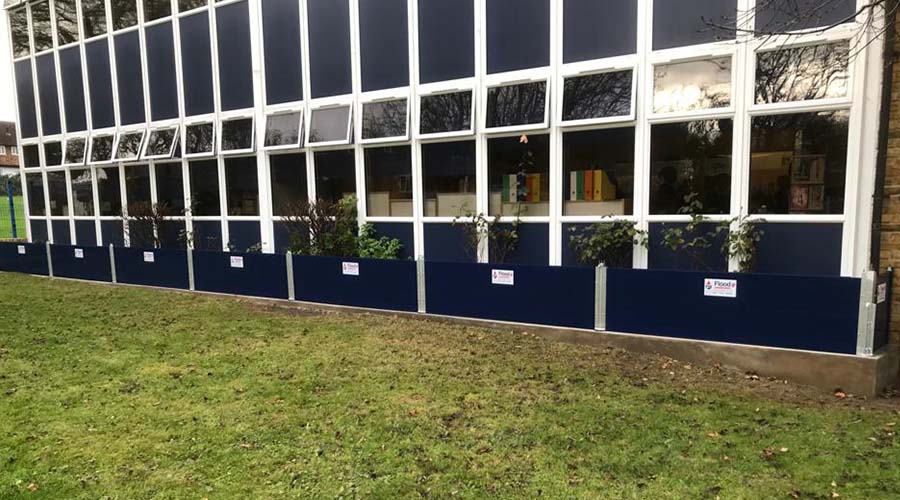 Installation of Nautilus flood barriers custom finished in blue power coating to match aesthetics of the to primary school brand.